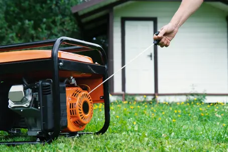portable generator being started manually