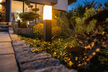 warm landscape lighting on stone path