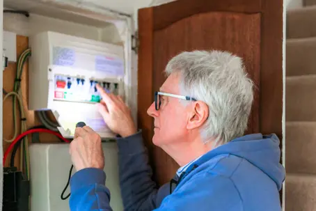an older man checking his fuse box