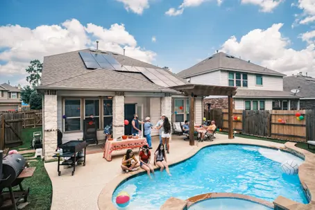 family gathering by a backyard pool