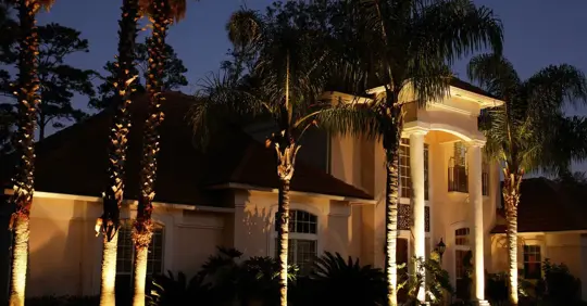 home illuminated by landscape lighting